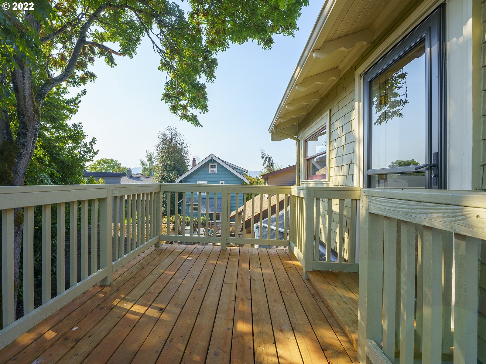 2424 Southeast Caruthers Street Portland, OR 97214 - Photo 24 of 32 a view of balcony with wooden floor and outdoor seating