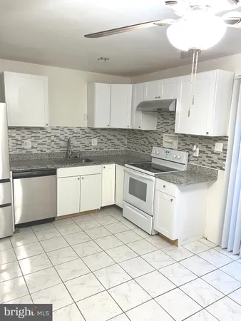 a kitchen with stainless steel appliances granite countertop a sink and cabinets