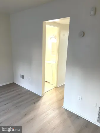 an empty room with wooden floor and a window