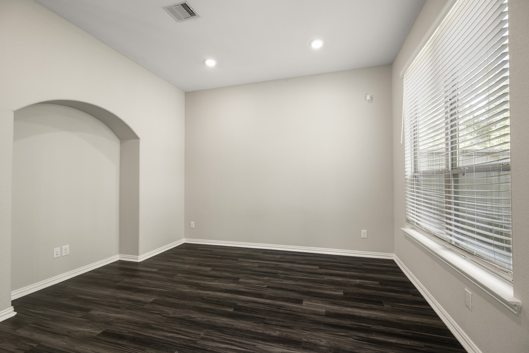 162 Moon Dance Court Conroe, TX 77304 - Photo 11 of 36 a view of an empty room with wooden floor and a window