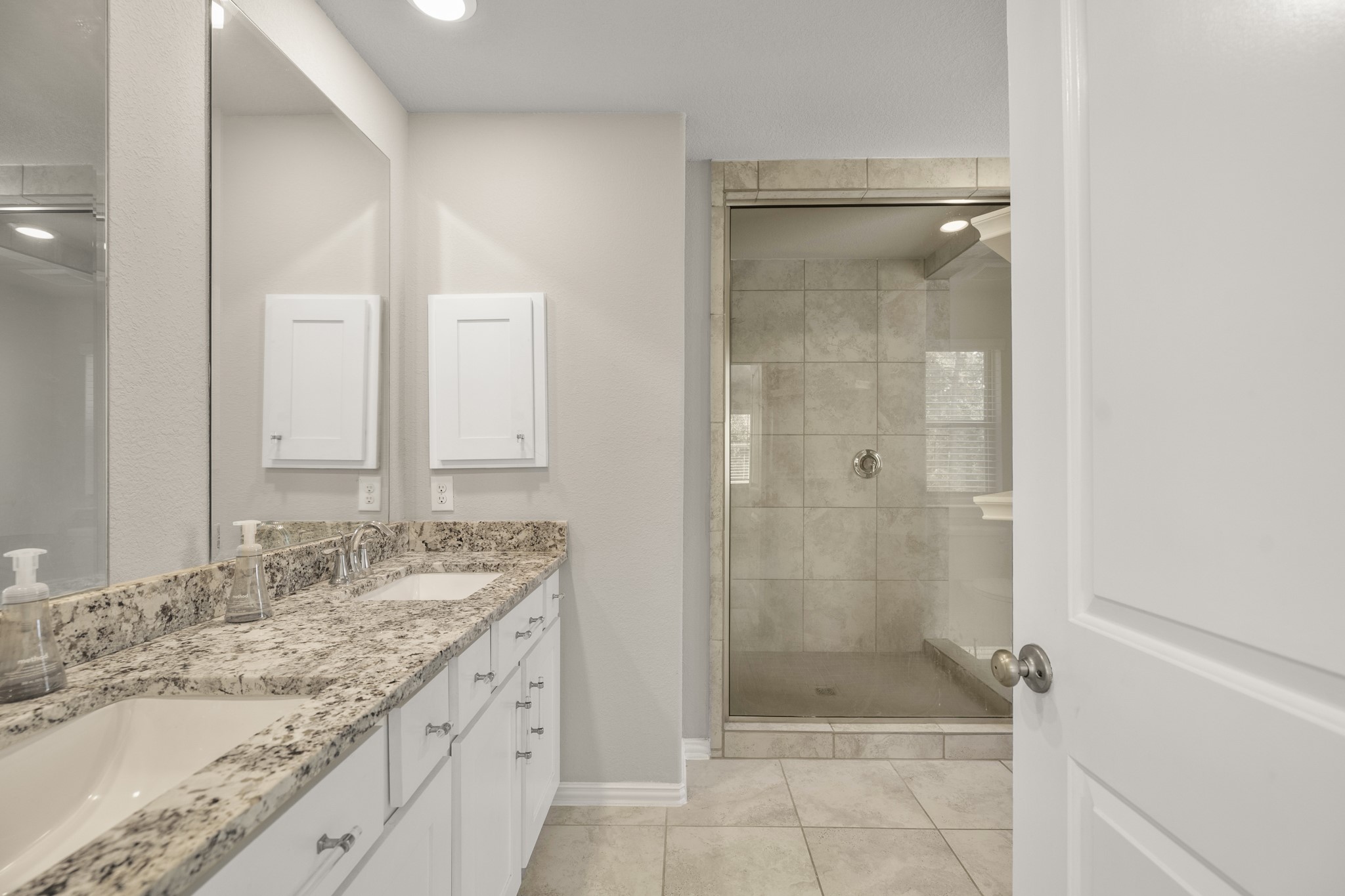 162 Moon Dance Court Conroe, TX 77304 - Photo 19 of 36 a bathroom with a granite countertop sink mirror shower and