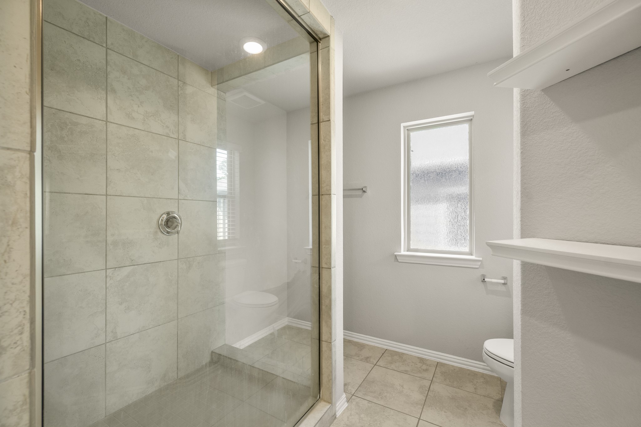162 Moon Dance Court Conroe, TX 77304 - Photo 20 of 36 a bathroom with a shower and toilet