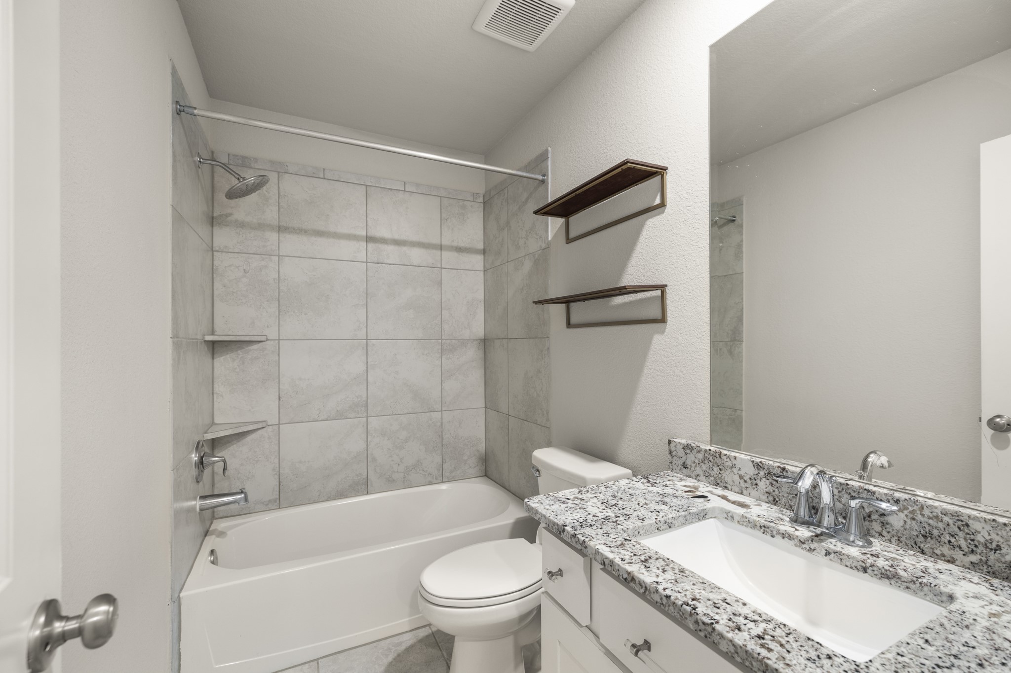 162 Moon Dance Court Conroe, TX 77304 - Photo 25 of 36 a bathroom with a granite countertop bathtub shower sink vanity mirror and toilet