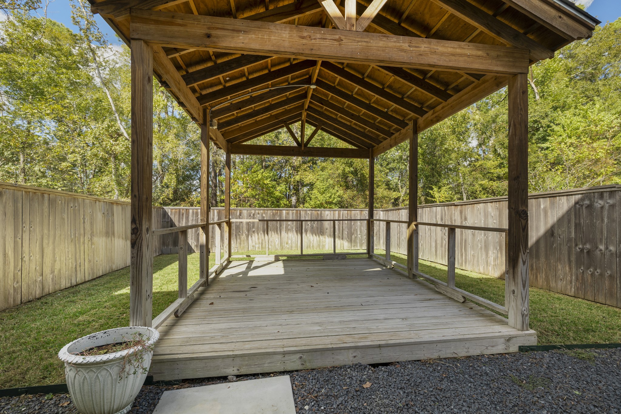 162 Moon Dance Court Conroe, TX 77304 - Photo 30 of 36 a porch with wooden floor in front of a house