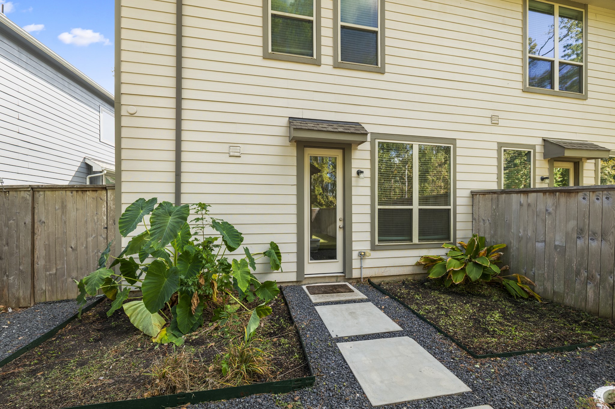 162 Moon Dance Court Conroe, TX 77304 - Photo 32 of 36 a house with potted plants in front of door