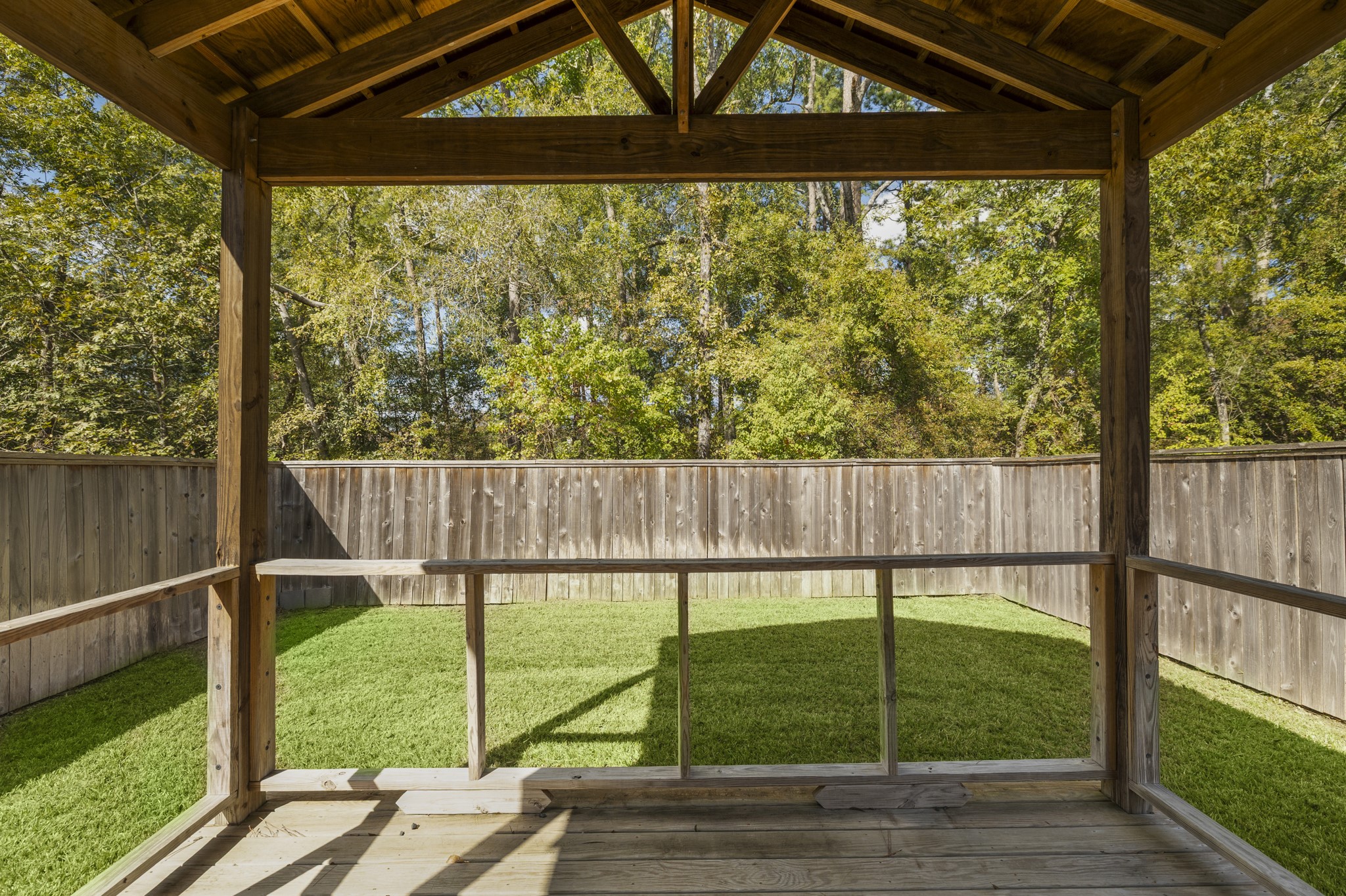 162 Moon Dance Court Conroe, TX 77304 - Photo 33 of 36 a view of a yard with wooden fence