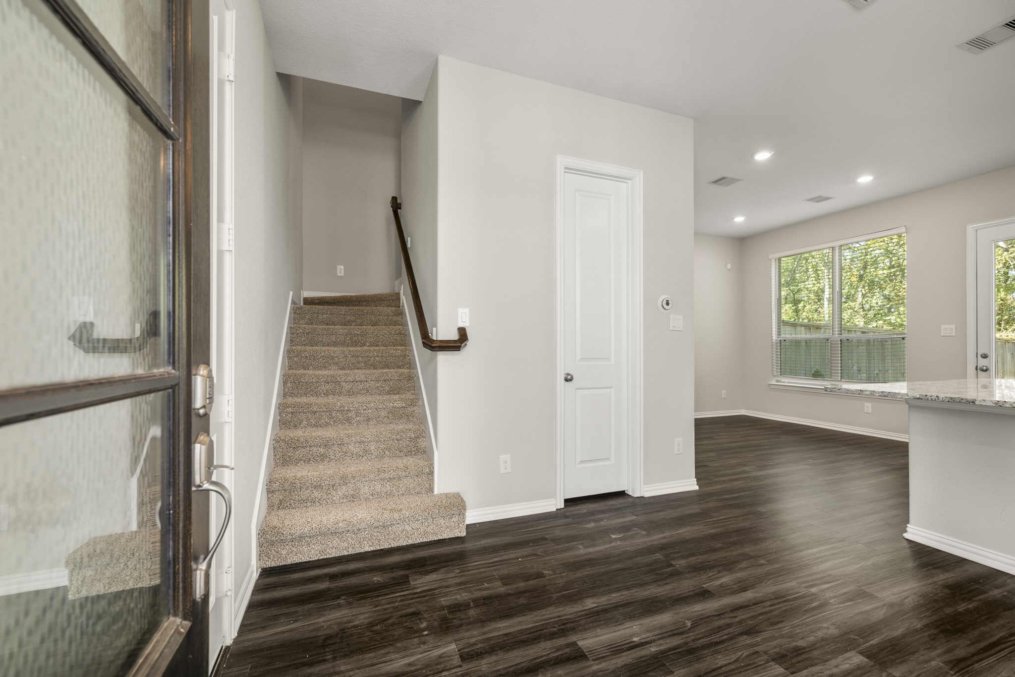 162 Moon Dance Court Conroe, TX 77304 - Photo 4 of 36 a view of entryway with wooden floor and stair