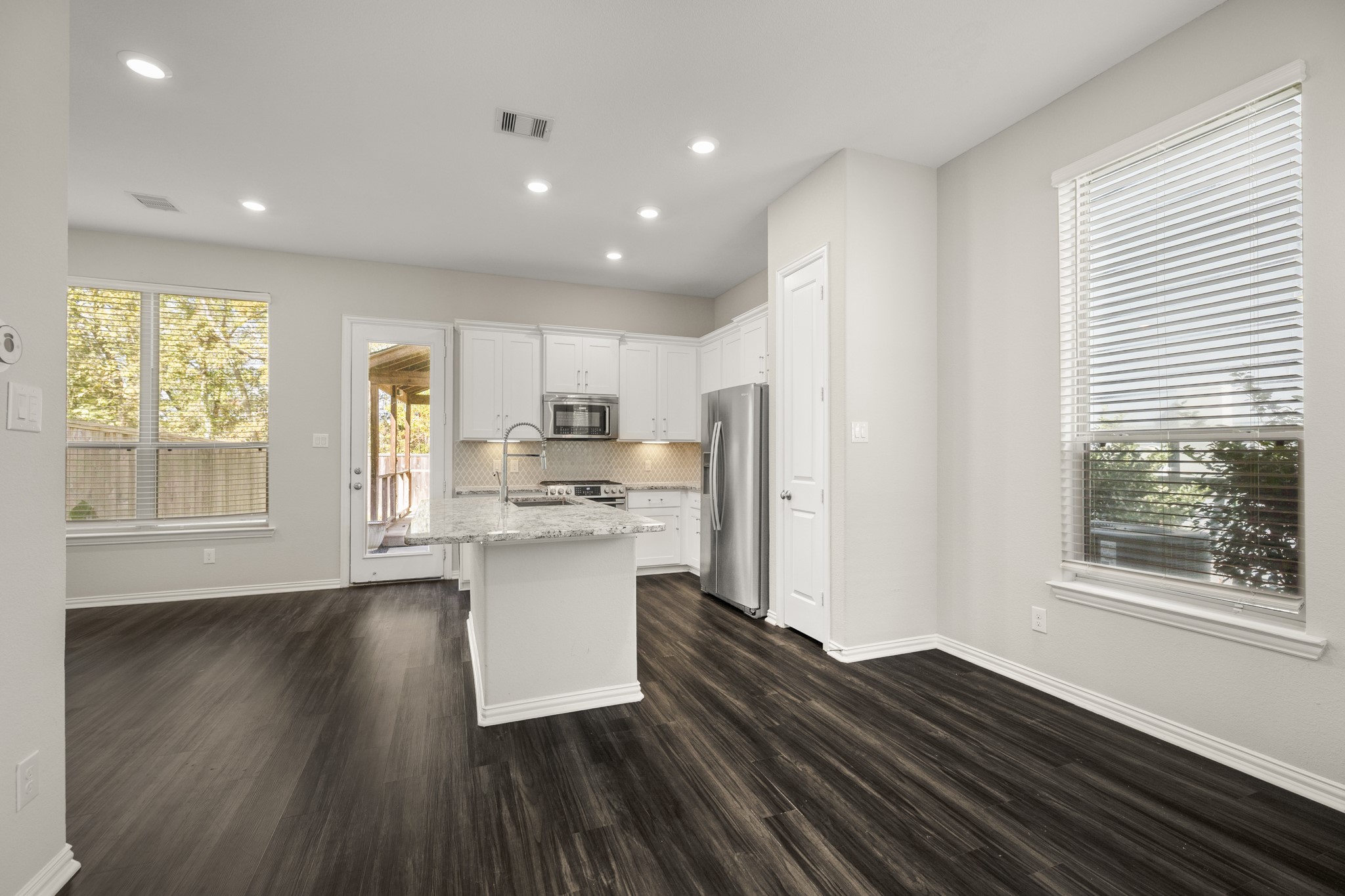 162 Moon Dance Court Conroe, TX 77304 - Photo 5 of 36 a open kitchen with kitchen island wooden floors and stainless steel appliances