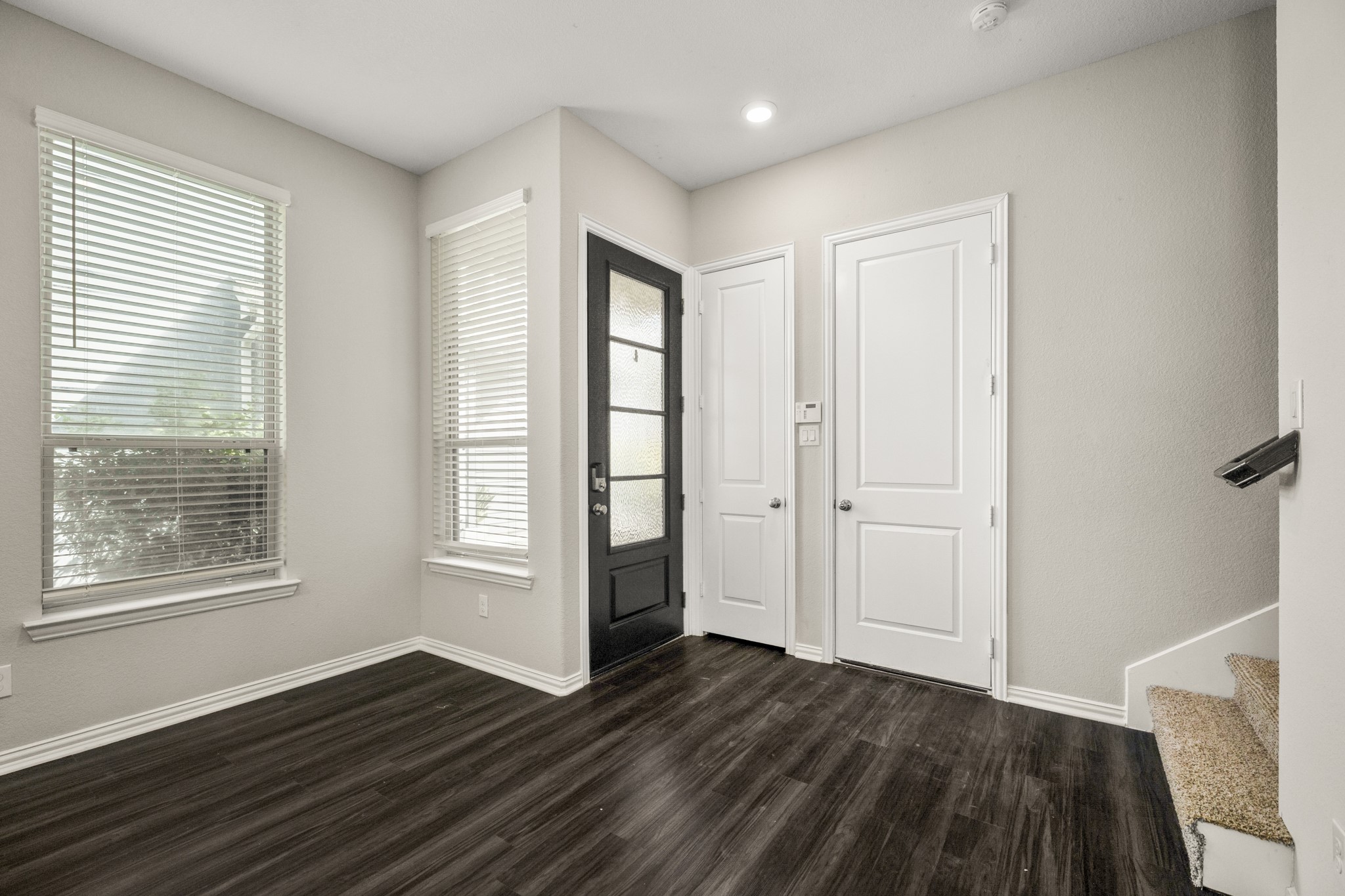 162 Moon Dance Court Conroe, TX 77304 - Photo 6 of 36 a view of an empty room with wooden floor and a window