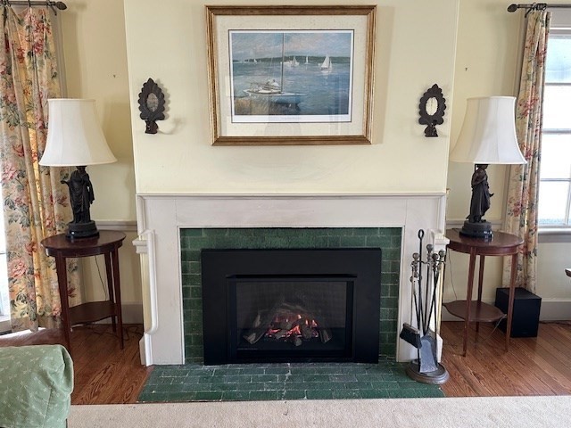 48 Proctor Street Manchester, MA 01944 - Photo 36 of 39 a living room with a fireplace and a wooden floor