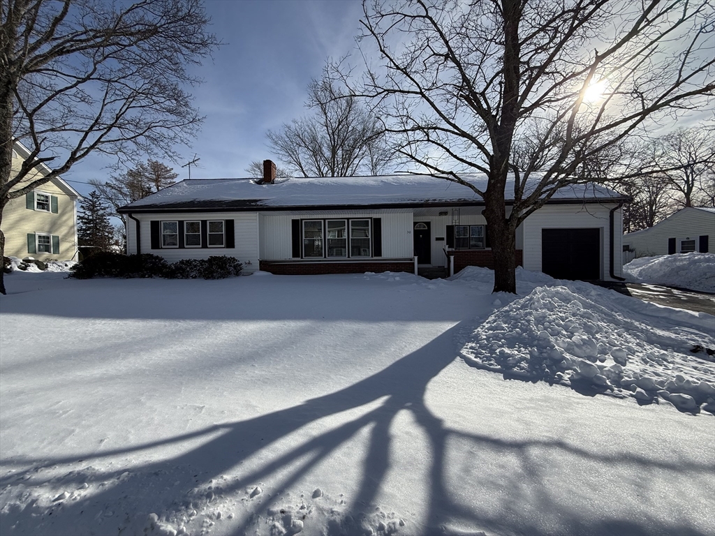 a view of a house with a yard covered in snow