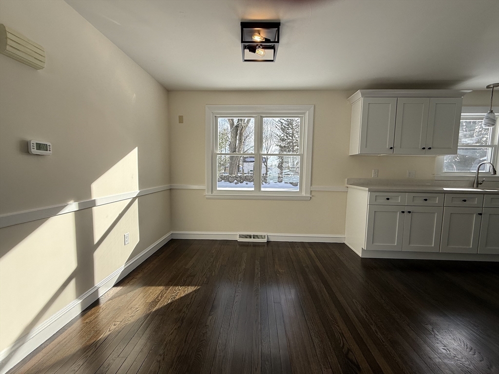 30 Alroy Road Weymouth, MA 02190 - Photo 12 of 40 a view of an empty room with wooden floor and a window