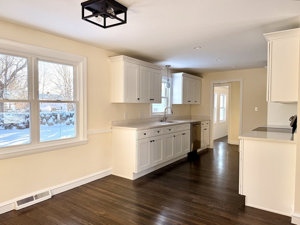 30 Alroy Road Weymouth, MA 02190 - Photo 14 of 40 a kitchen with a refrigerator wooden floor and a window