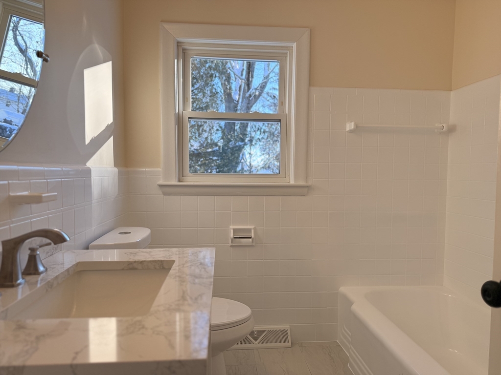 30 Alroy Road Weymouth, MA 02190 - Photo 19 of 40 a bathroom with a sink toilet and window