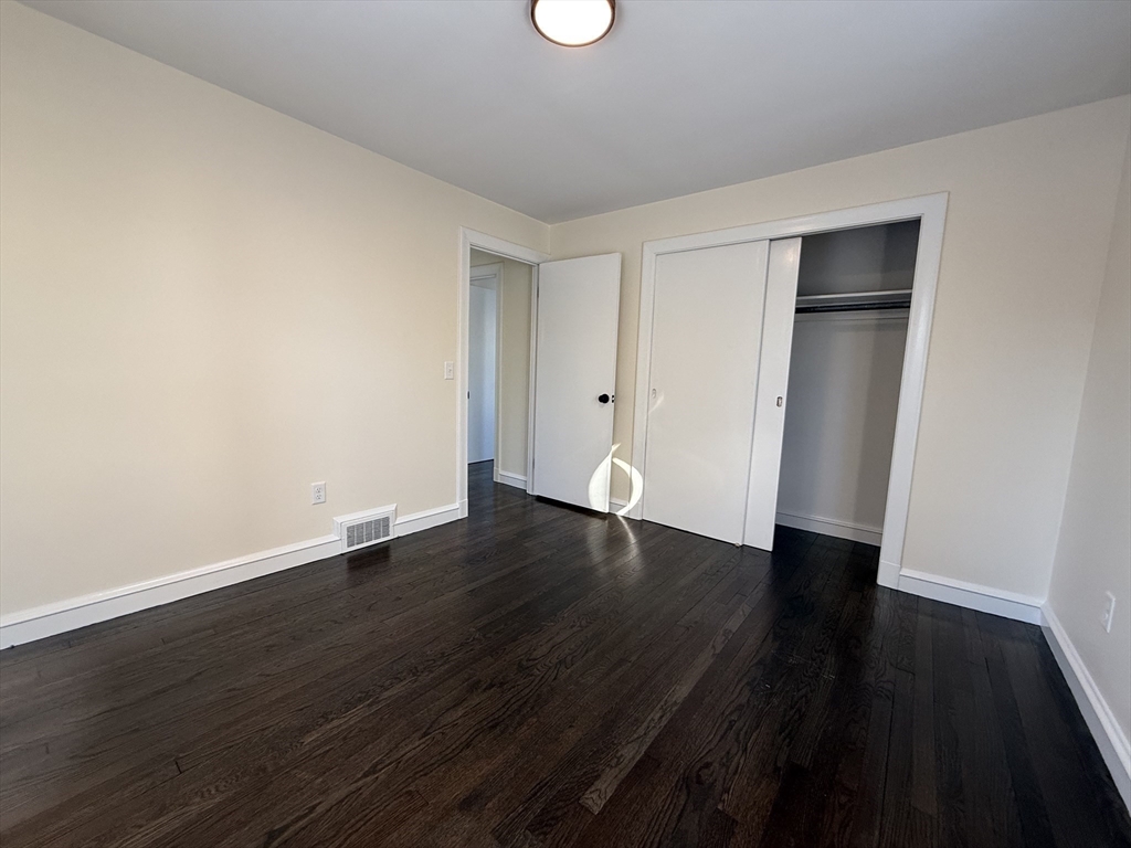 30 Alroy Road Weymouth, MA 02190 - Photo 29 of 40 a view of an empty room with wooden floor and a window