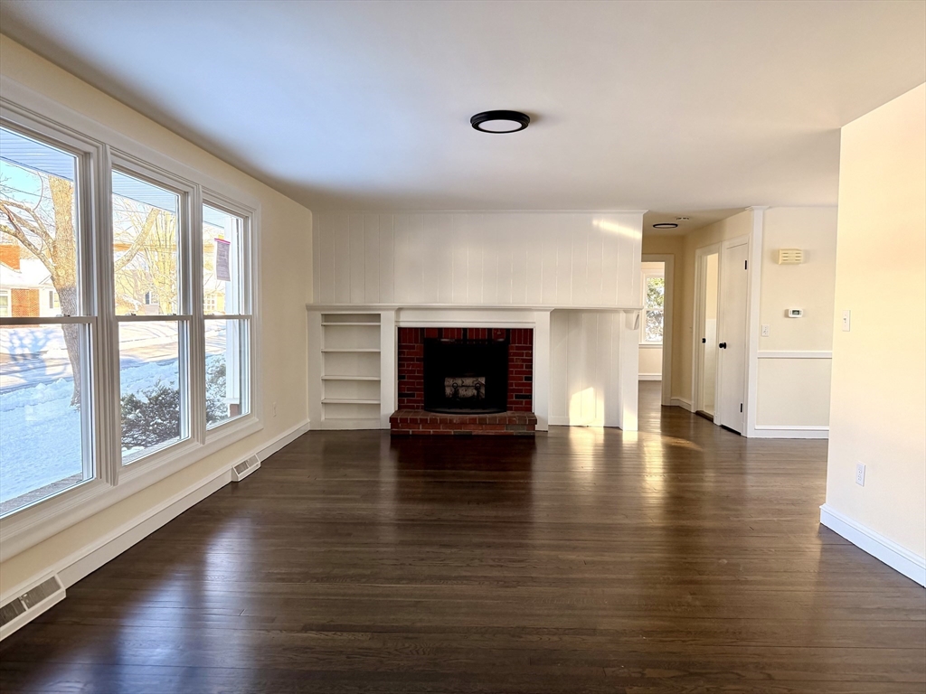 30 Alroy Road Weymouth, MA 02190 - Photo 7 of 40 a view of empty room with wooden floor and fireplace