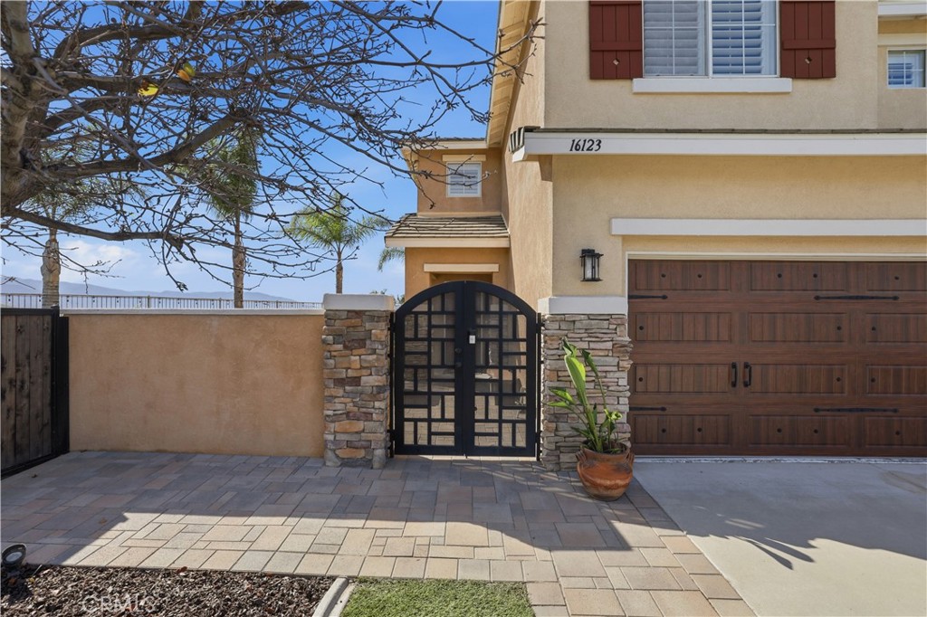 16123 Setting Sun Circle Riverside, CA 92503 - Photo 11 of 67 a view of a brick house with many windows