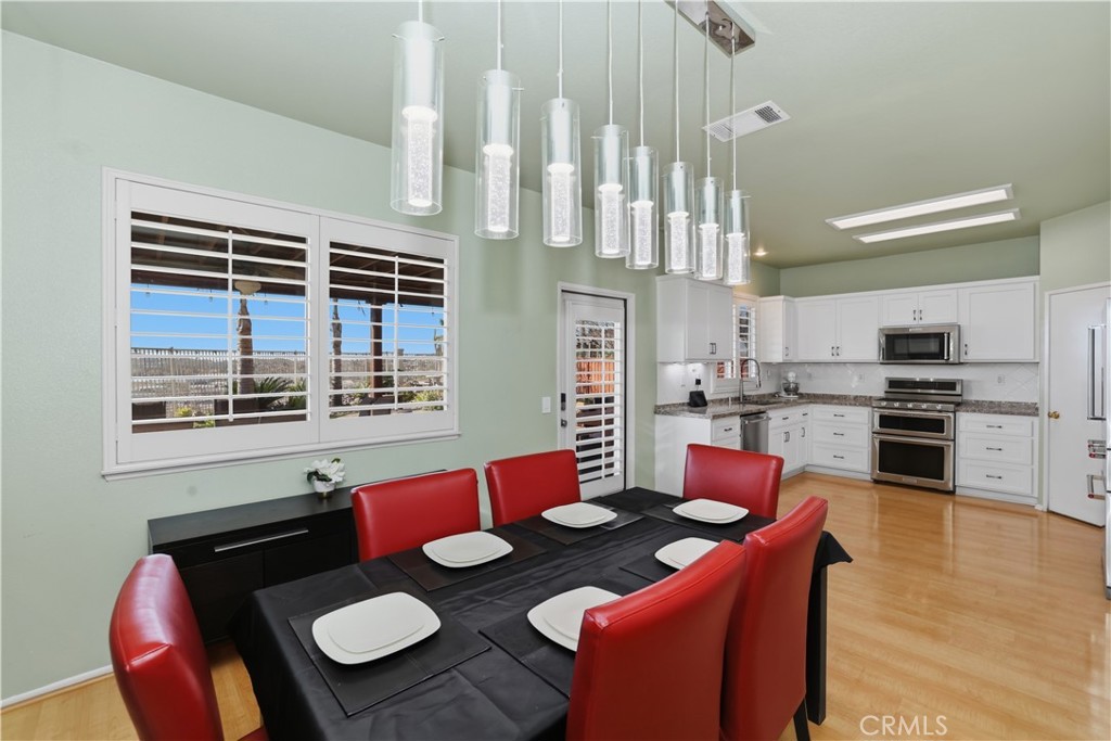 16123 Setting Sun Circle Riverside, CA 92503 - Photo 21 of 67 a open dining room with furniture kitchen view and a large window