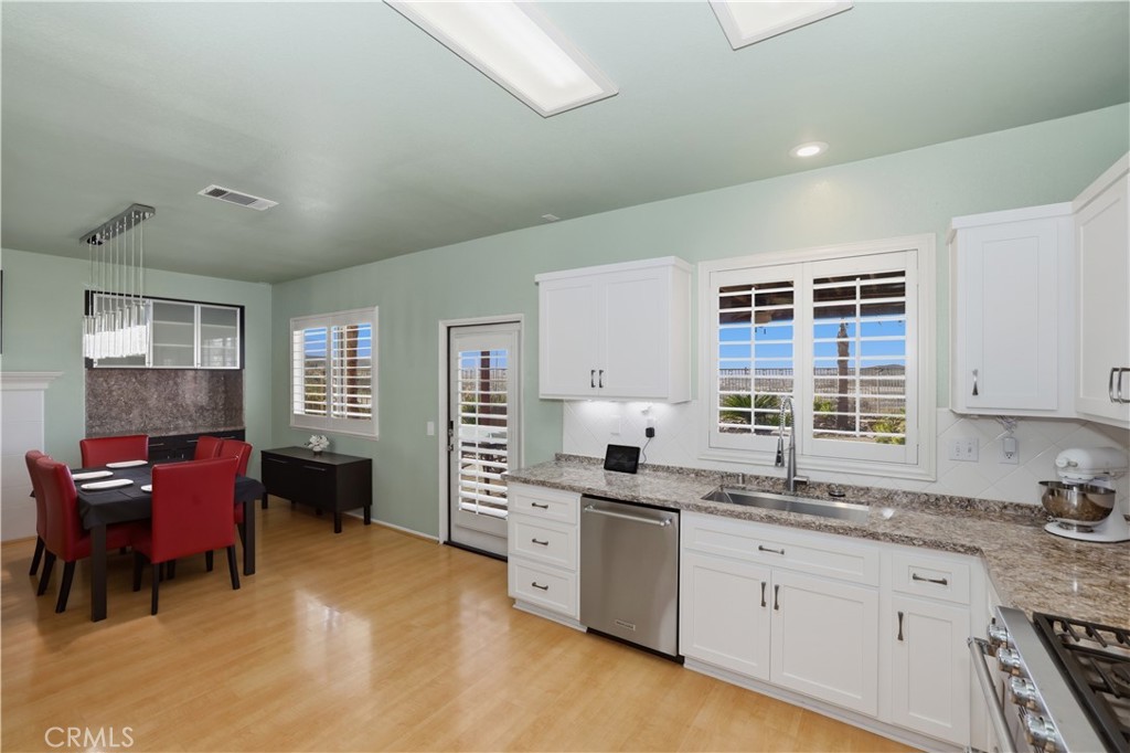 16123 Setting Sun Circle Riverside, CA 92503 - Photo 22 of 67 a kitchen with granite countertop a sink cabinets and window