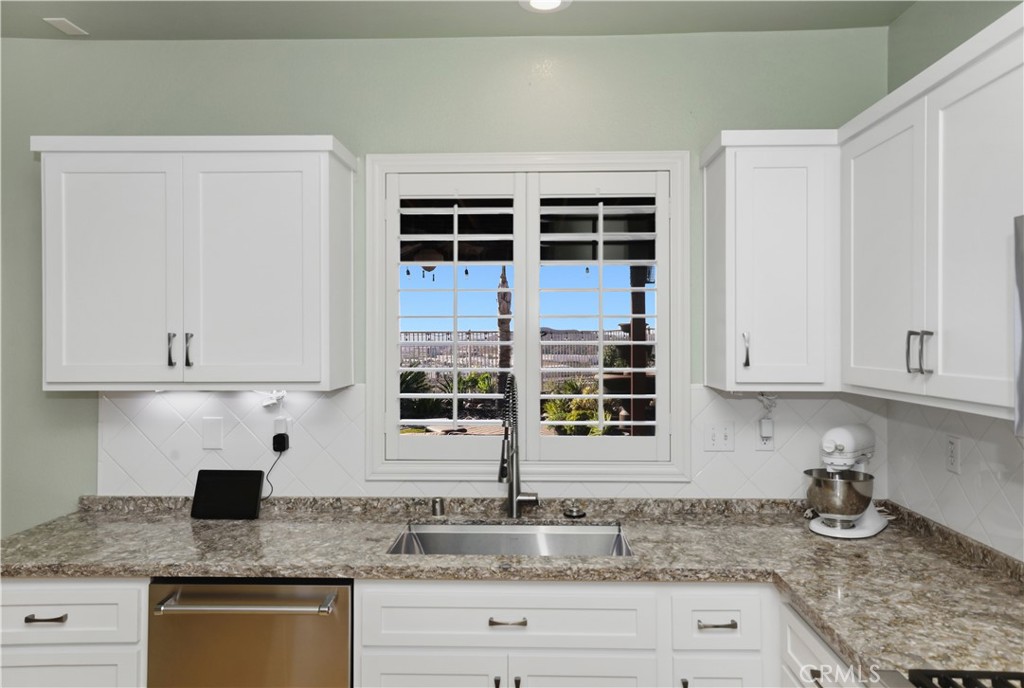 16123 Setting Sun Circle Riverside, CA 92503 - Photo 24 of 67 a kitchen with granite countertop a sink a stove and cabinets