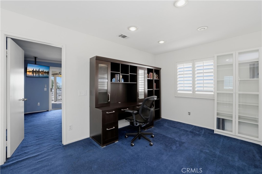16123 Setting Sun Circle Riverside, CA 92503 - Photo 27 of 67 a view of a workspace with furniture and a window