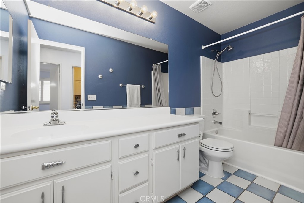 16123 Setting Sun Circle Riverside, CA 92503 - Photo 29 of 67 a bathroom with a double vanity sink toilet and shower
