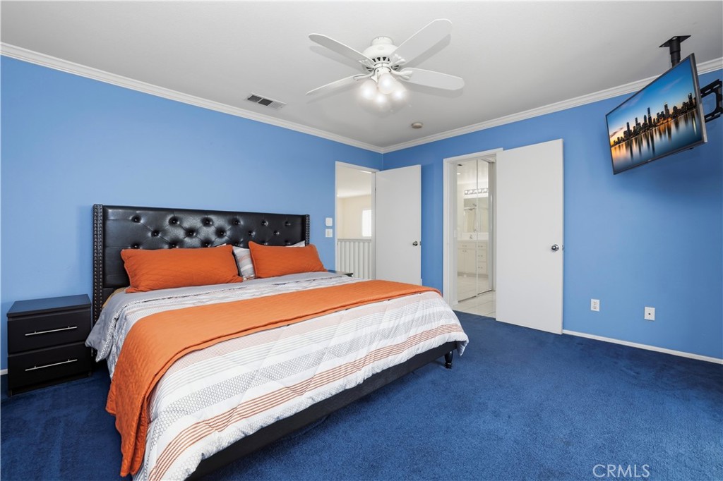 16123 Setting Sun Circle Riverside, CA 92503 - Photo 32 of 67 a bedroom with a large bed and a chandelier