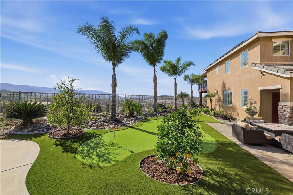 16123 Setting Sun Circle Riverside, CA 92503 - Photo 46 of 67 a view of a swimming pool with a garden