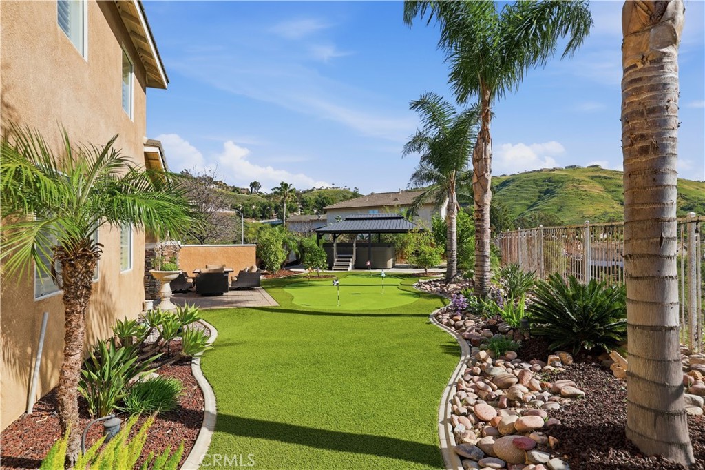 16123 Setting Sun Circle Riverside, CA 92503 - Photo 47 of 67 a view of a backyard with plants and a garden