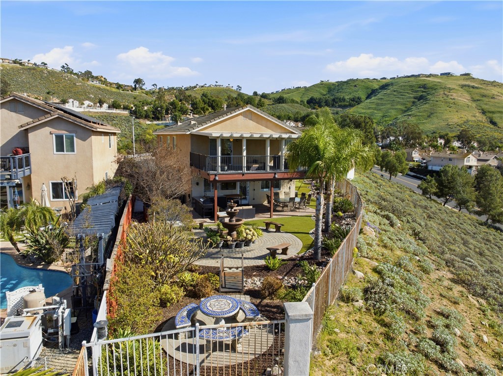 16123 Setting Sun Circle Riverside, CA 92503 - Photo 52 of 67 a view of a balcony with dining table and chairs with an umbrella