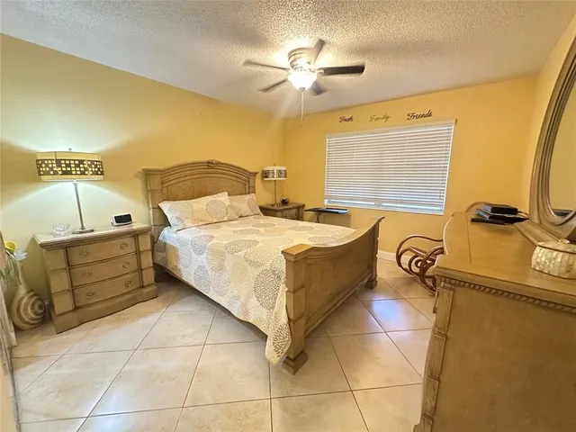 a bed room with a bed and a chandelier