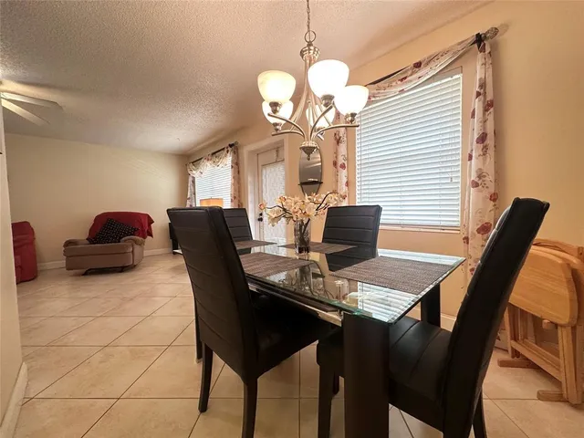 a view of a dining room with furniture and chandelier