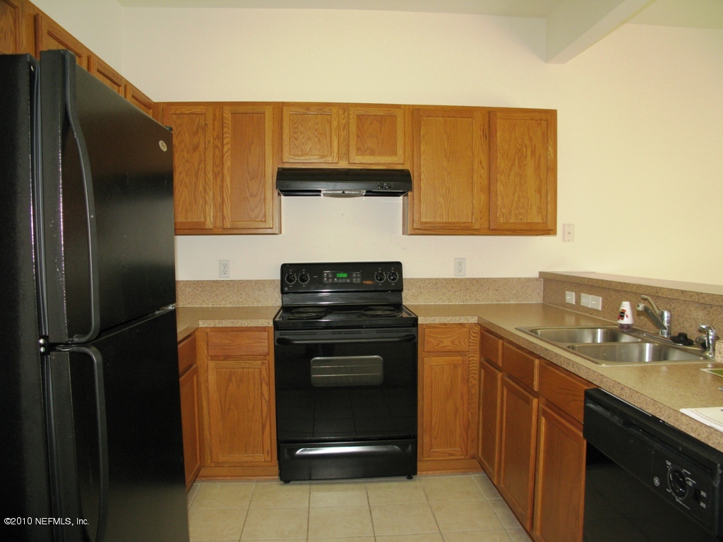 5880 Sandstone Way Jacksonville, FL 32258 - Photo 15 of 20 a kitchen with a sink and a refrigerator