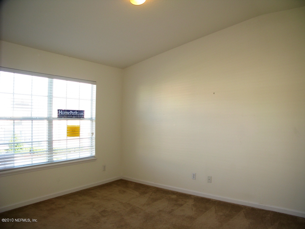 5880 Sandstone Way Jacksonville, FL 32258 - Photo 17 of 20 an empty room with a window