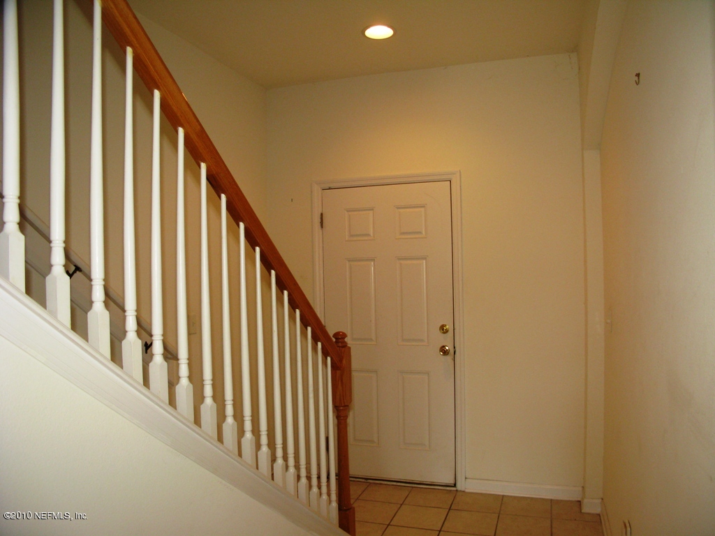 5880 Sandstone Way Jacksonville, FL 32258 - Photo 3 of 20 a view of staircase with railing and white walls