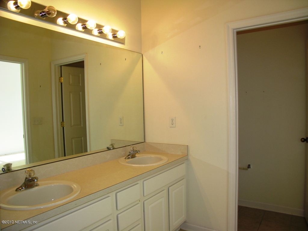 5880 Sandstone Way Jacksonville, FL 32258 - Photo 8 of 20 a bathroom with a sink and a mirror