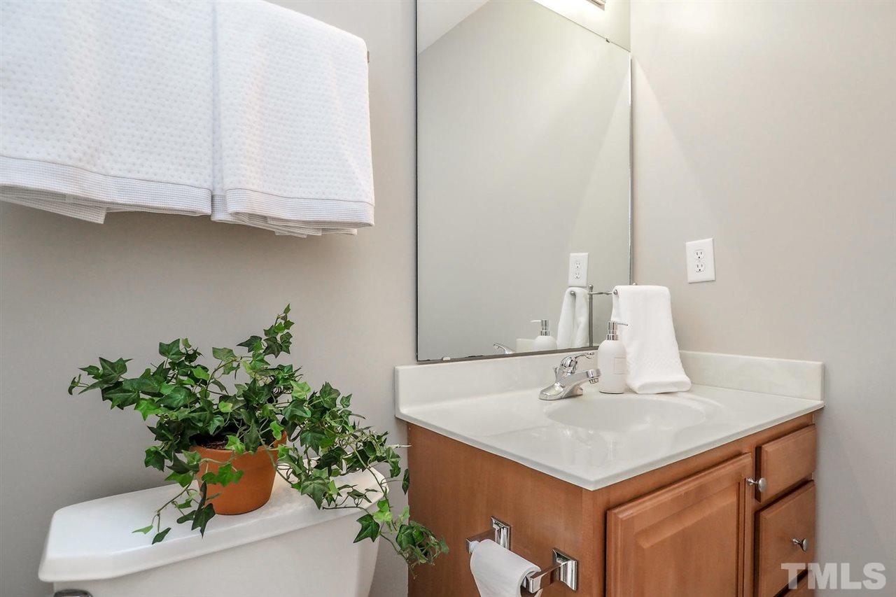 2041 Rivergate Road, Unit 105 Raleigh, NC 27614 - Photo 6 of 9 a bathroom with a sink and a mirror