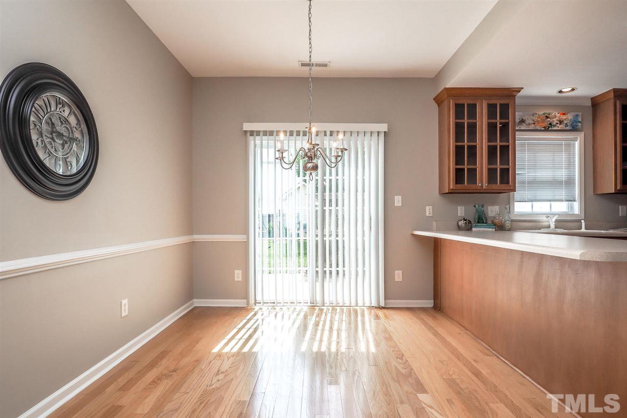 2041 Rivergate Road, Unit 105 Raleigh, NC 27614 - Photo 9 of 9 a view of a kitchen with a fridge wooden floor and a window
