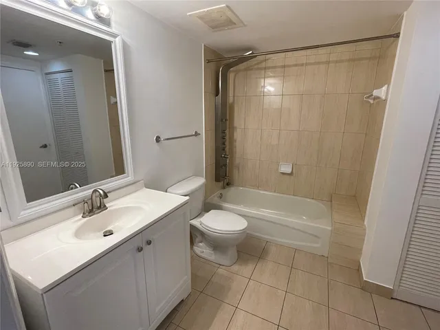a bathroom with a double vanity sink toilet and shower