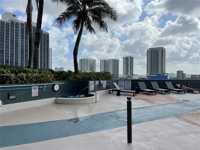 a swimming pool with potted plants and palm trees