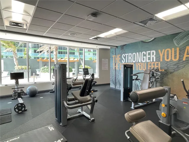 a living room with furniture a fireplace and a large window