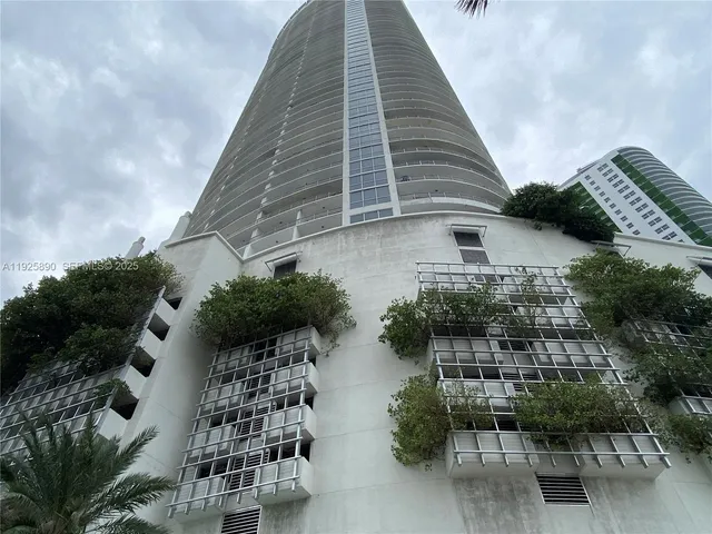 a balcony with plants and outdoor seating