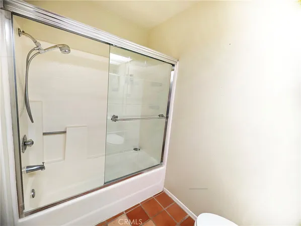 a bathroom with a glass shower door