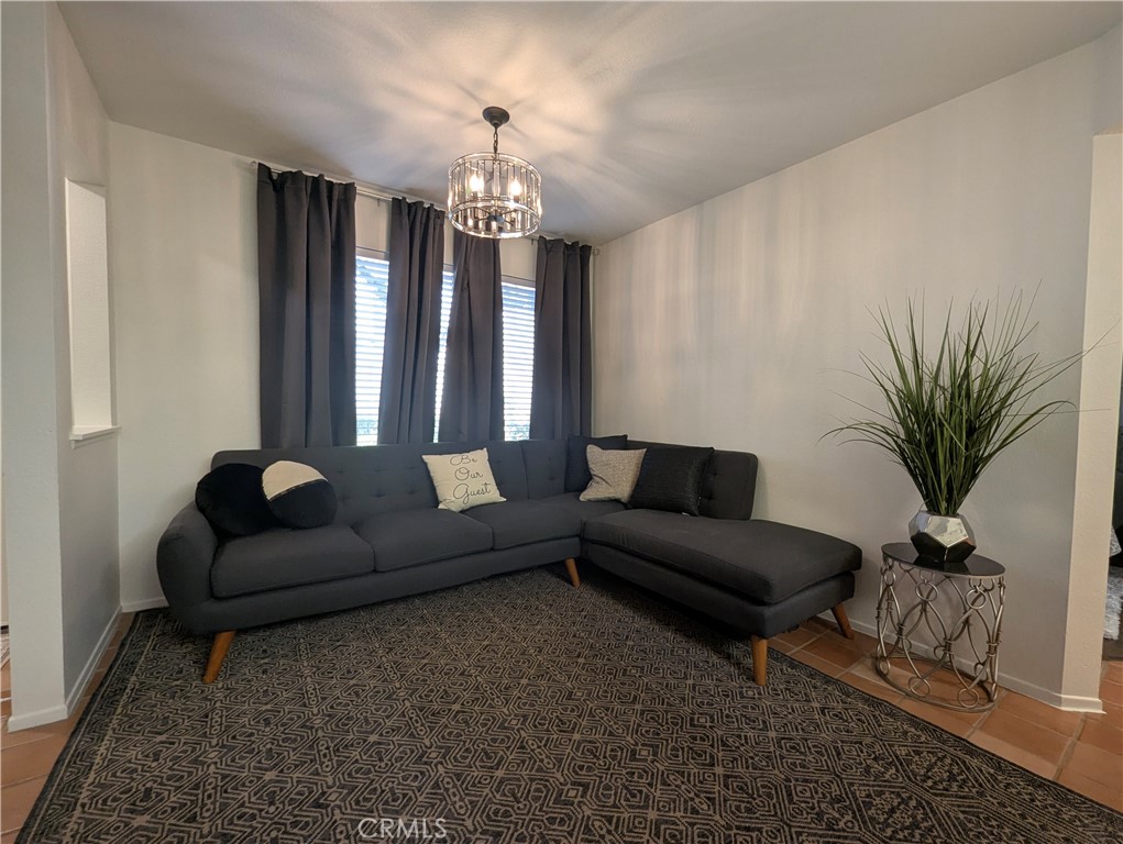 73 Brisa Del Lago Rancho Santa Margarita, CA 92688 - Photo 6 of 12 a living room with furniture and a chandelier