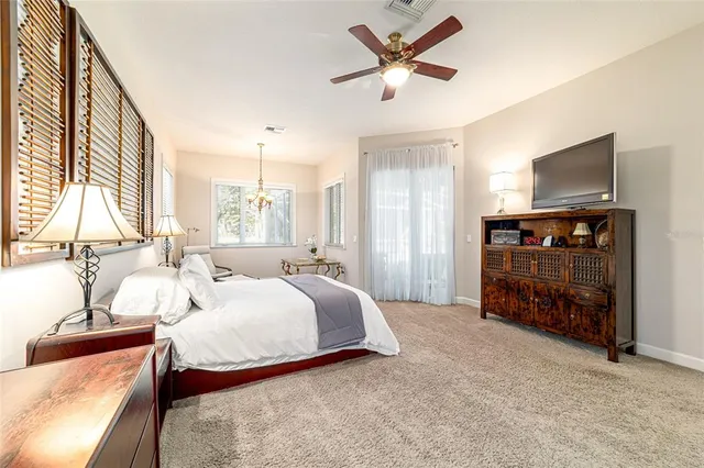 a aerial view of a house with swimming pool and large trees