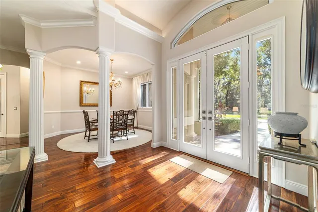 a large kitchen with stainless steel appliances granite countertop a stove top oven a sink dishwasher a dining table and chairs with wooden floor