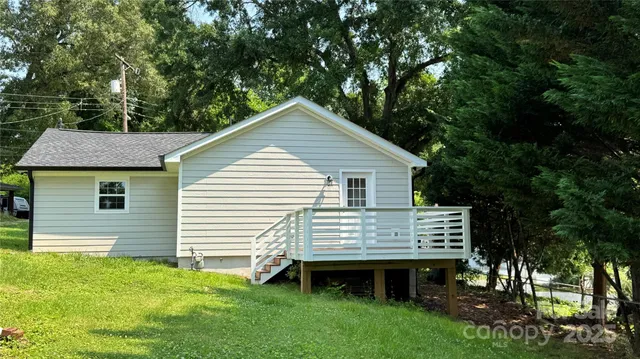 a view of a house with a yard and sitting area