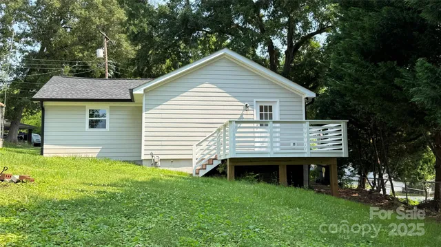 a view of a house with a yard and sitting area