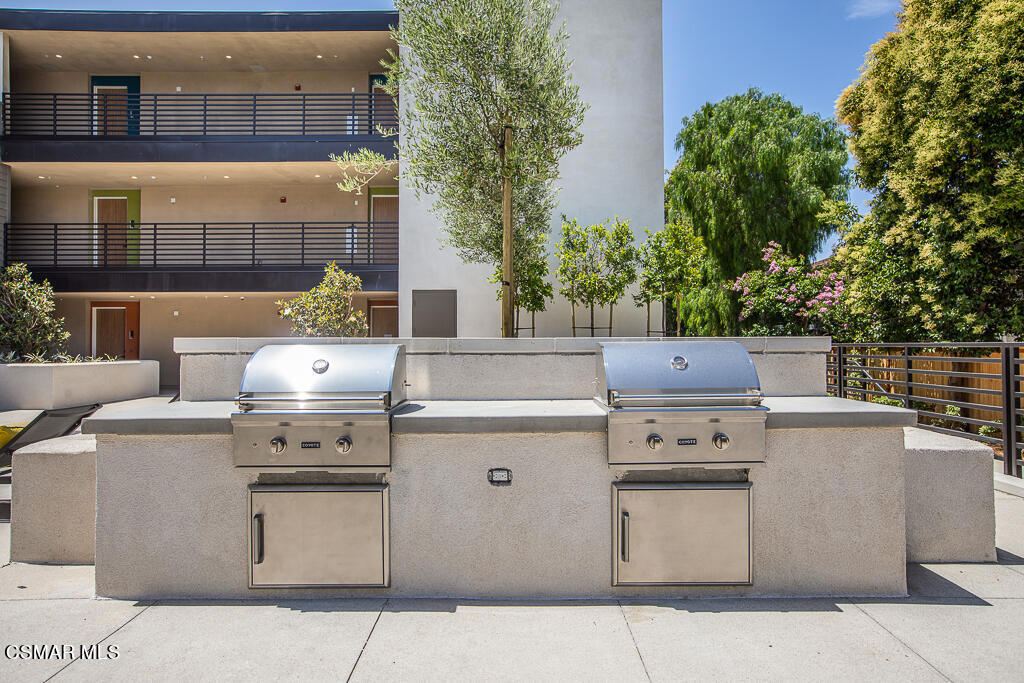 77 North Conejo School Road, Unit 217 Thousand Oaks, CA 91362 - Photo 12 of 15 a stove top oven sitting inside of a kitchen