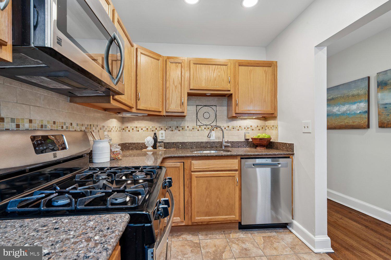 1652 Kramer Street Northeast Washington, DC 20002 - Photo 6 of 26 a kitchen with stainless steel appliances a sink a stove a refrigerator and cabinets